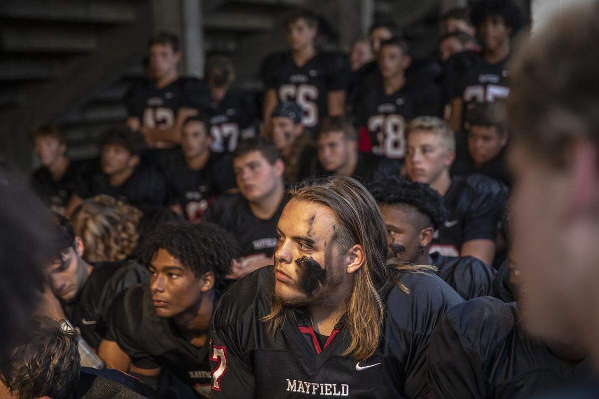 Mayfield’s Wyatt Inman, center bottom, and his teammates listen as coach Joe Morris speaks.