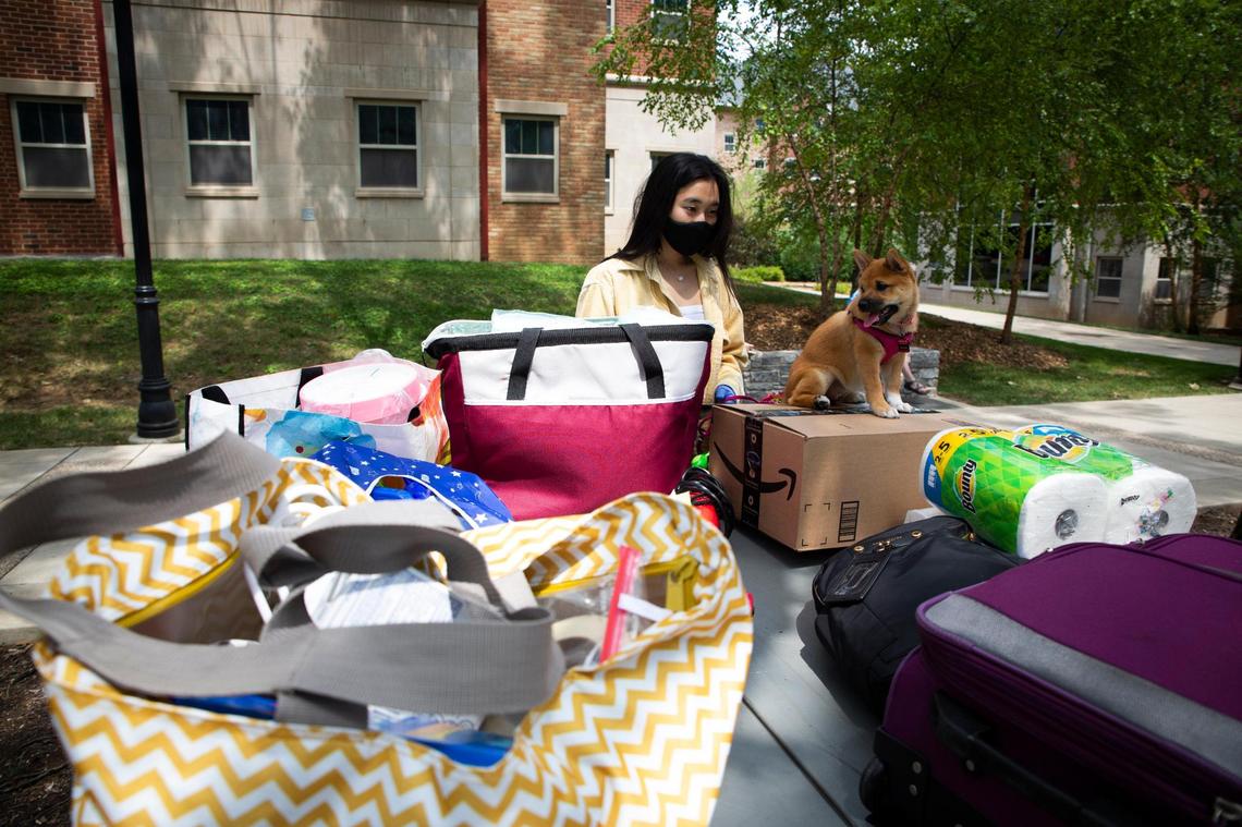 Freshman accounting major Eumin Shin and her emotional support dog, Prada, wait to move into Shin’s dorm on the University of Kentucky campus in Lexington, Ky., on Saturday, August 8, 2020. UK had about 1,000 of their total 6,500 students living in dorms move in on Saturday with social distancing and other safety measures in place because of the COVID-19 pandemic.
