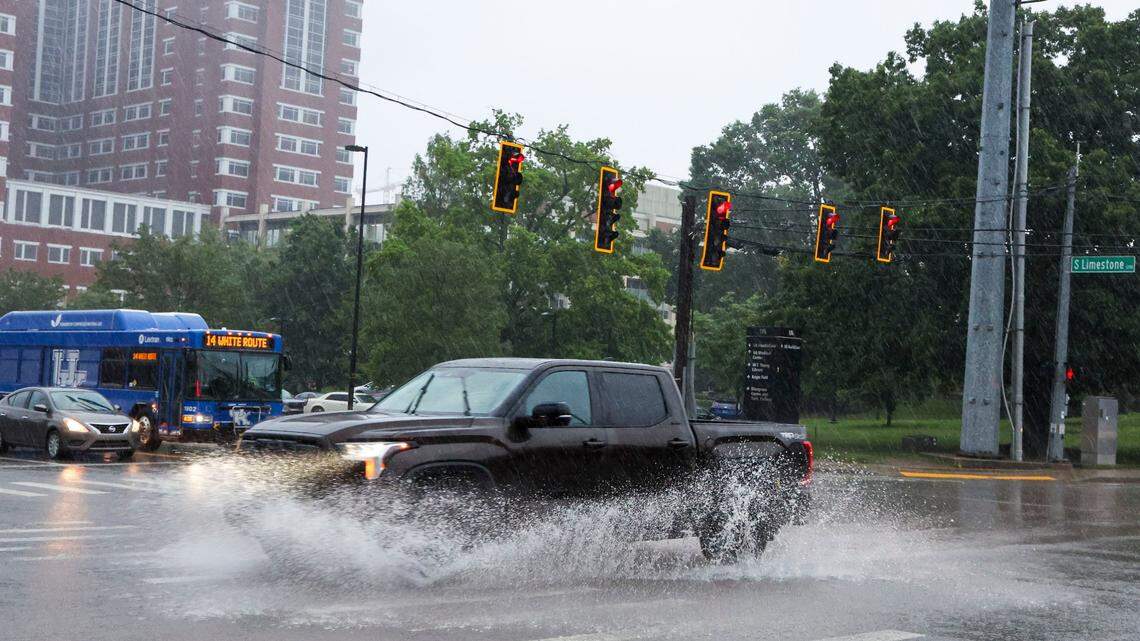 A truck drives through standing water during a rush-hour rainstorm at the intersection of South Limestone and Waller Avenue, Friday, May 30, 2025 in Lexington, Ky.