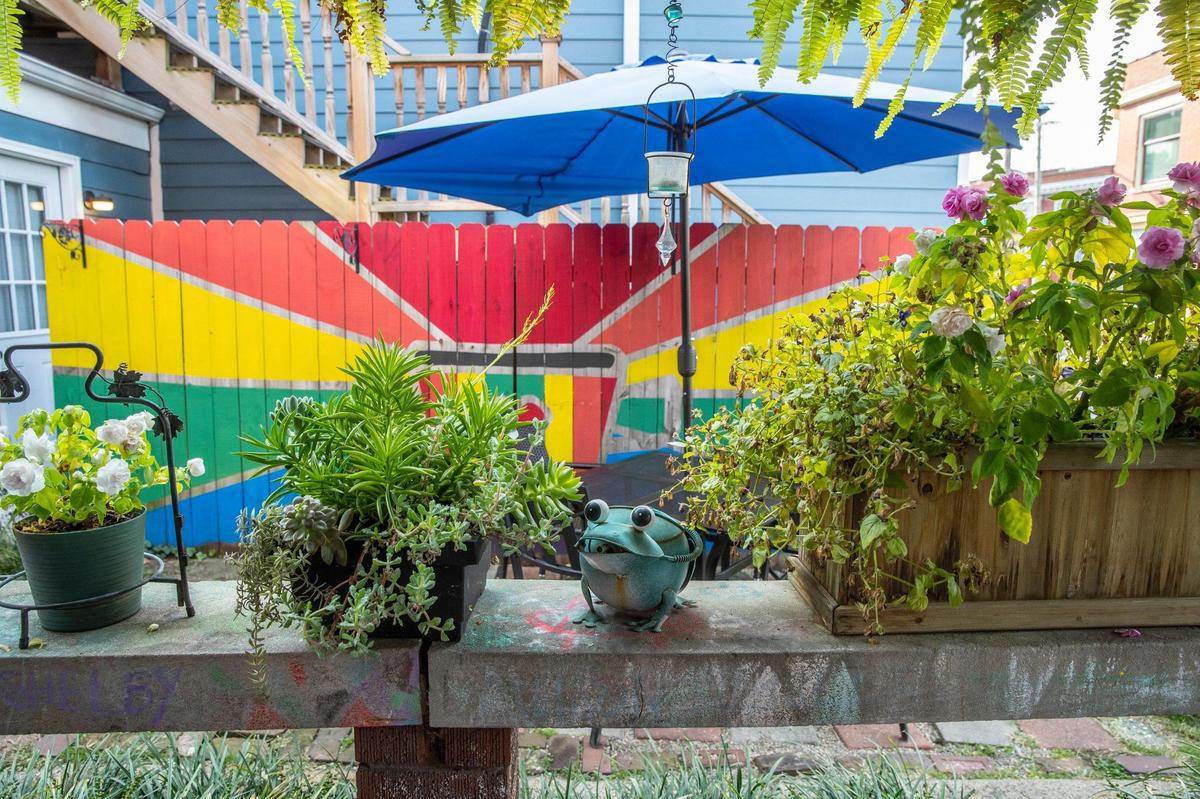 A garden area offers outdoor seating at High on Art & Coffee at 523 East High St. in Lexington, Ky., on Thursday, Oct. 21, 2021. While the inside of the shop is currently closed to customers because of COVID-19 precautions, the garden area has tables, chairs, colorful art and benches.