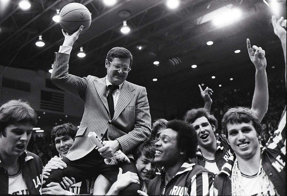 UK players gave Coach Joe B. Hall a lift after the Wildcats defeated Indiana 92-90 in the 1975 NCAA Tournament Mideast Regional finals in Dayton, Ohio. The UK players, from left, were: Danny Hall, Rick Robey, Jimmy Dan Conner, Marion Haskins, Mike Phillips and Mike Flynn.