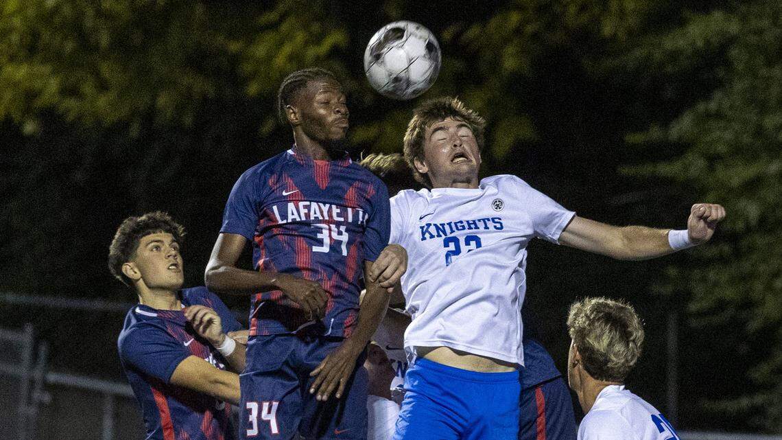 Lafayette's Assani Kalonda (34), left, and Lexington Catholic's Kalin Osting (22) battle for the ball during the Generals 4-0 win over the Knights in the 43rd District championship game, Thursday, Oct. 9, 2025 at Lexington Catholic in Lexington, Ky.