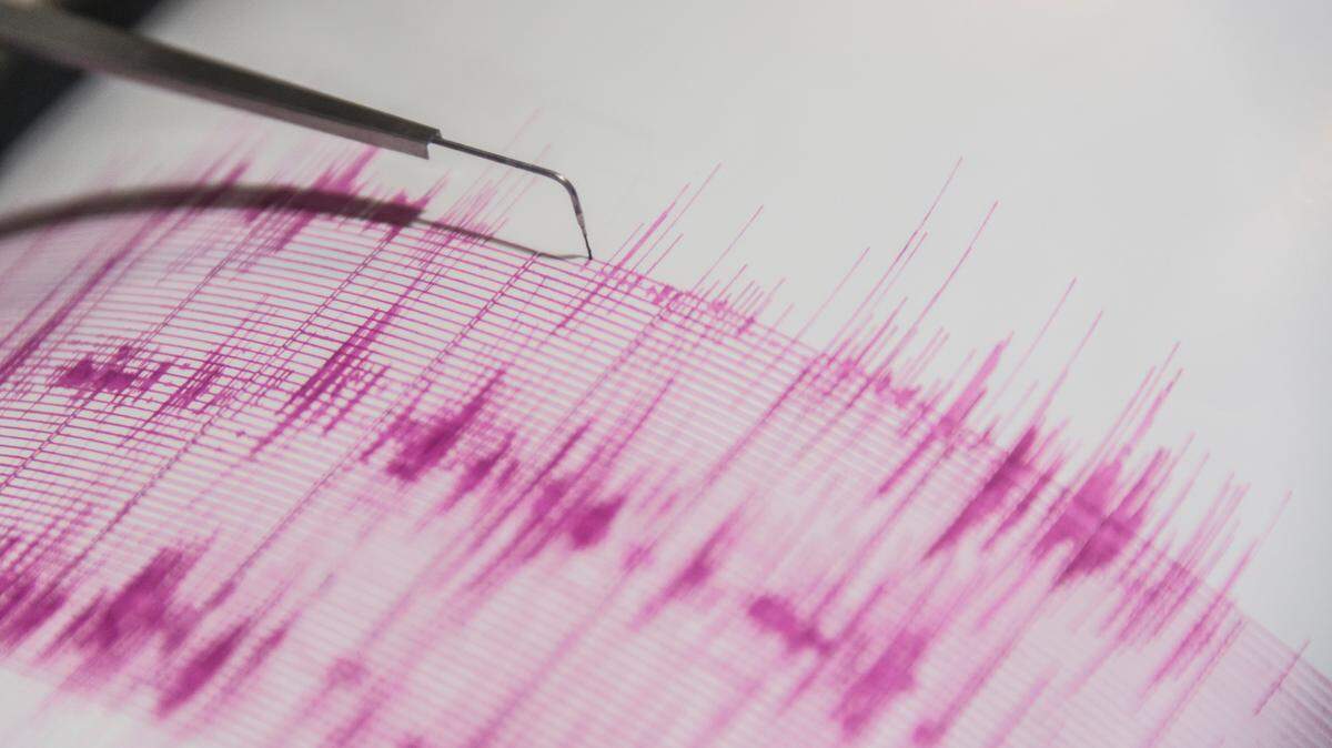 A needle moves along a paper surface in this stock image of a seisometer.