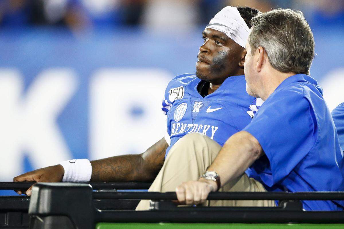 Kentucky quarterback Terry Wilson, left, leaves the field on a cart after suffering an injury to his left knee during UK’s 38-17 win against Eastern Michigan in 2019. It was subsequently learned that Wilson had suffered a torn patella tendon, sidelining him for the remainder of the season.