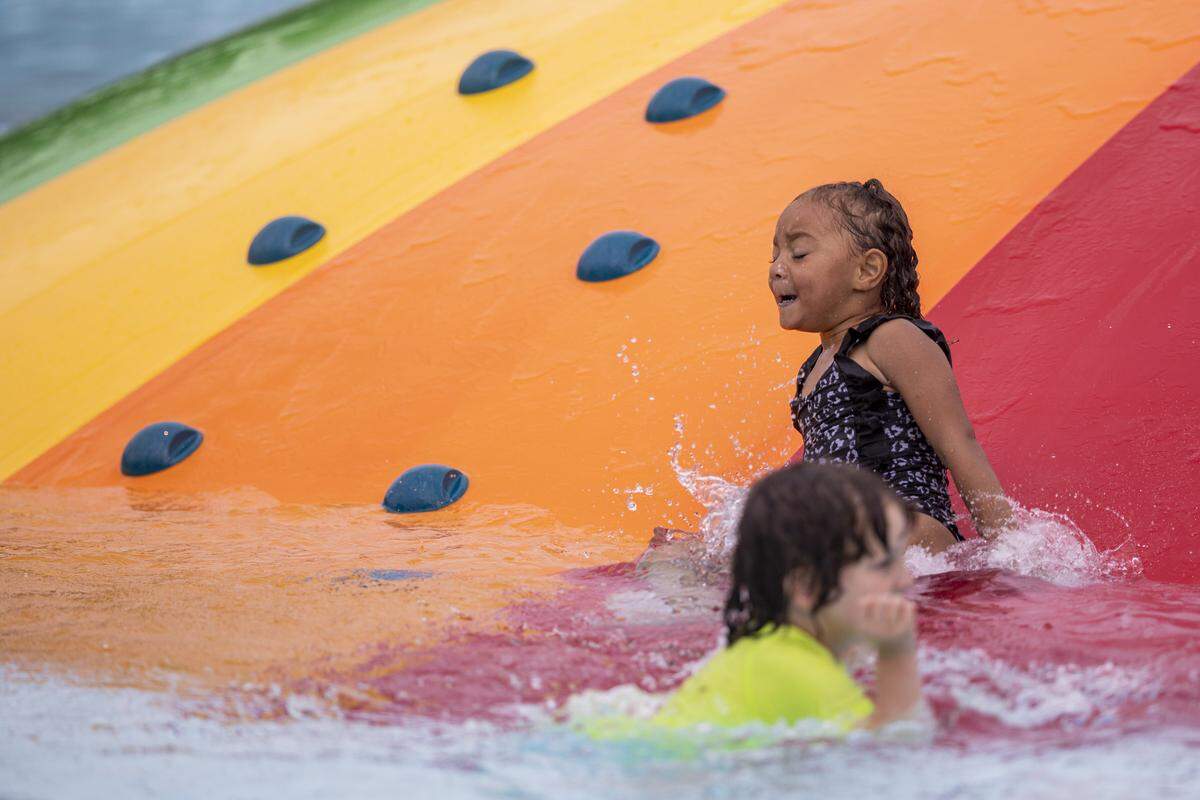 Kids play in the water during the Douglass Aquatic Center opening on Thursday, Aug. 21, 2025, at Douglass Park in Lexington, Ky. 