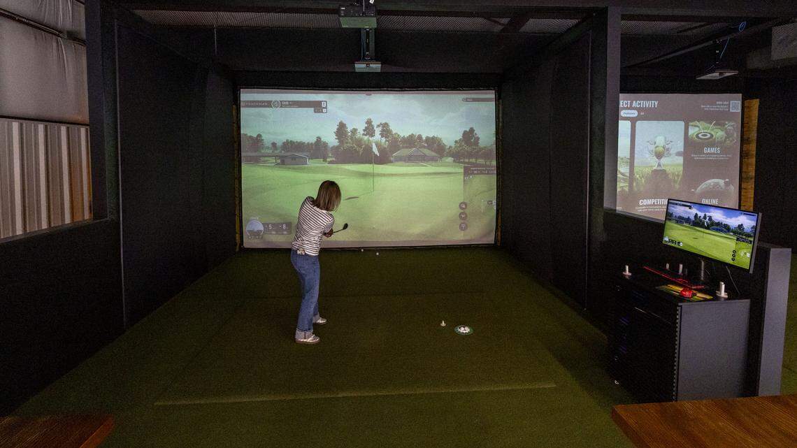 New bar with golf simulators opens in historic Midway location. See inside