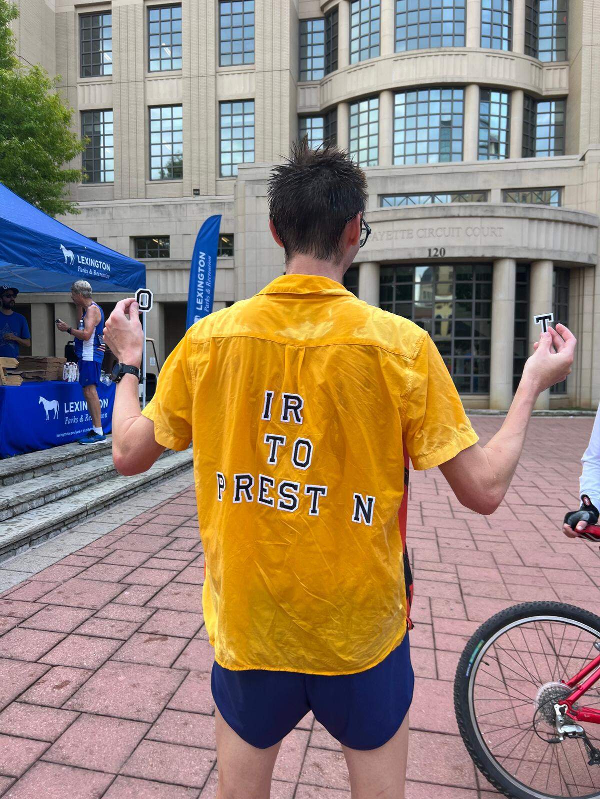 Overall winner Christopher Phillips-Hart celebrates being “First to Preston” following the 48th Bluegrass 10,000 and Fun Run.