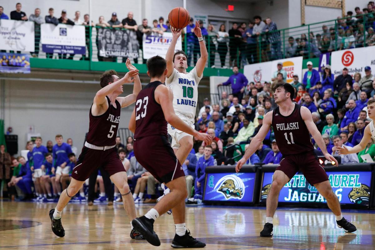 North Laurel’s Clay Sizemore (10) gets off a shot over three Pulaski County defenders. Sizemore made six three-point baskets and finished with 18 points.