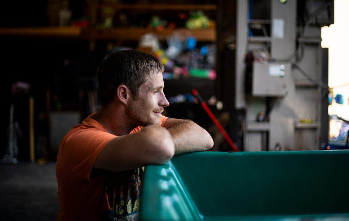 Jonathan Sparks, “Sparkie” takes a moment from working at the Methodist Mountain Mission and rests on a container in Jackson, Ky., Thursday, June 25, 2020.