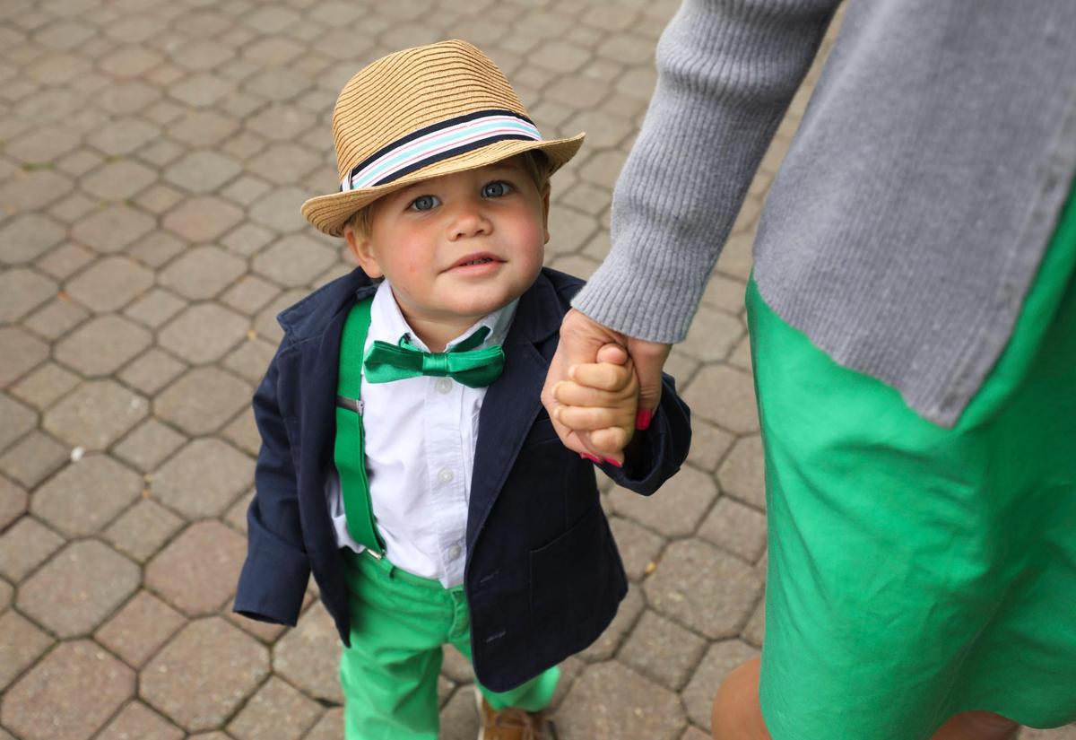 Otis Bollinger, from North Carolina, wears kelly green to match his mom, Maria, at Churchill Downs in Louisville, Ky., Saturday, May 7, 2022.