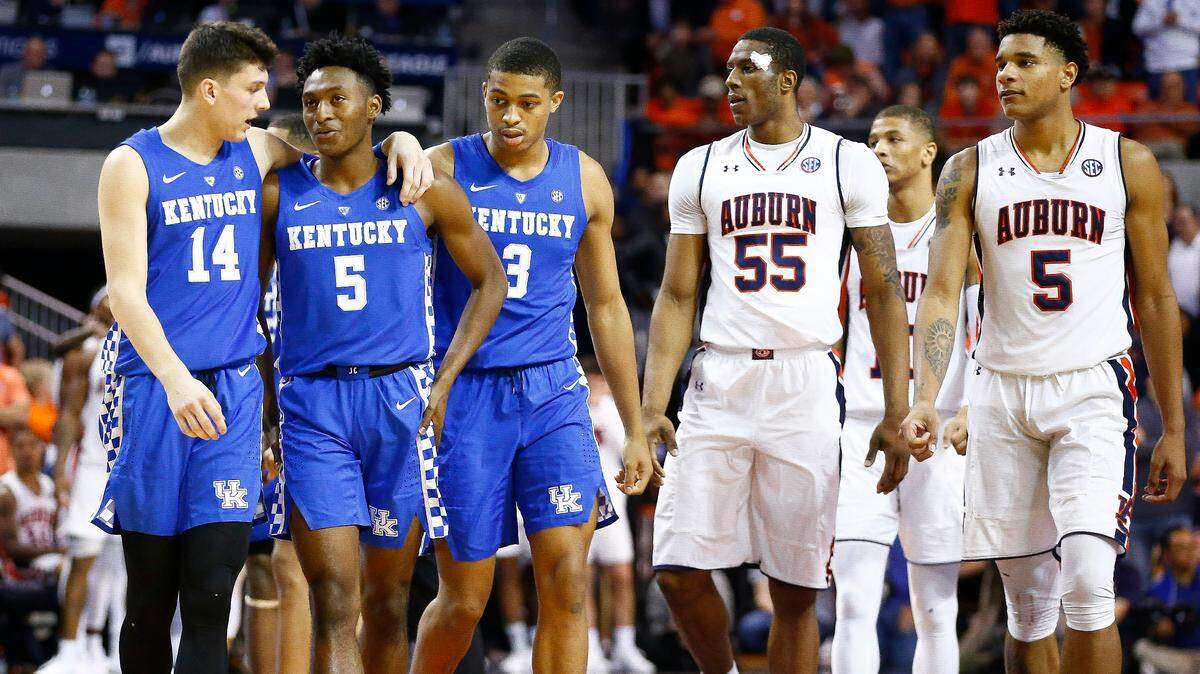 Kentucky’s Tyler Herro (14), Immanuel Quickley (5) and Keldon Johnson (3) returned to the court after a timeout against Auburn. The Cats won 82-80.