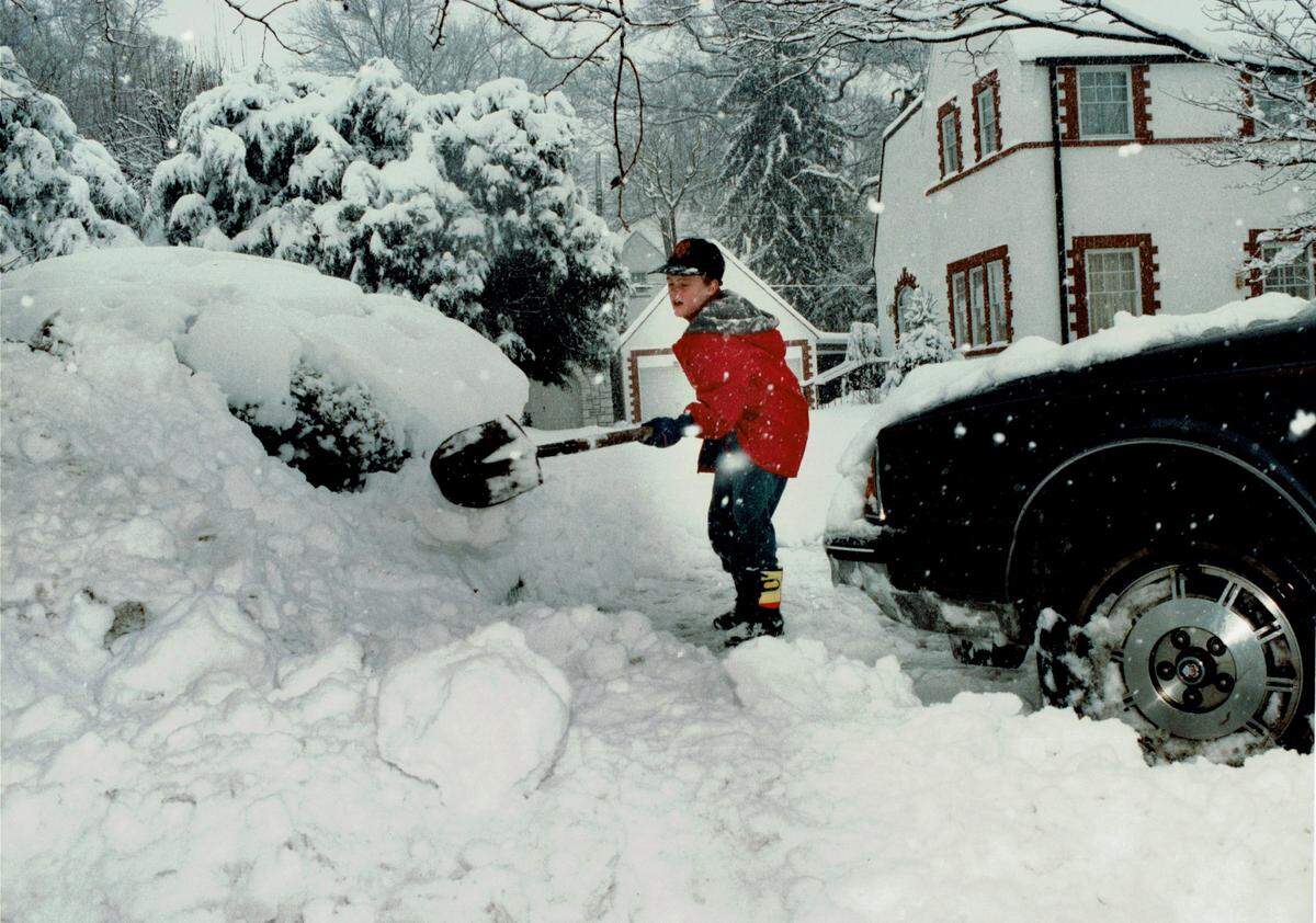 Mill Graves, 9, shoveled snow to clear his driveway on Richmond Road on January 17, 1994, as a major snow storm moved across the state. Snow depths ranged from 3 inches in southwestern Kentucky to 25 inches in Robertson County, the hardest hit spot in the state. Lexington had 10 inches. Louisville had 15.9 inches, breaking a record of 15.7 inches set 16 years prior to this snow, in the blizzard of 1978. Kentucky Governor Brereton Jones declared a state of emergency on the 17th and closed all the interstates and the Blue Grass Parkway. Photo by Mark Cornelison | Staff