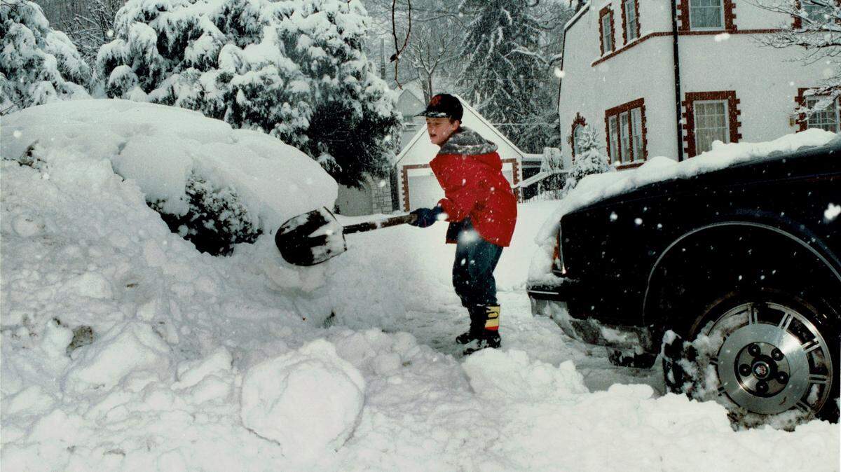 Mill Graves, 9, shoveled snow to clear his driveway on Richmond Road on January 17, 1994, as a major snow storm moved across the state. Snow depths ranged from 3 inches in southwestern Kentucky to 25 inches in Robertson County, the hardest hit spot in the state. Lexington had 10 inches. Louisville had 15.9 inches, breaking a record of 15.7 inches set 16 years prior to this snow, in the blizzard of 1978. Kentucky Governor Brereton Jones declared a state of emergency on the 17th and closed all the interstates and the Blue Grass Parkway. Photo by Mark Cornelison | Staff
