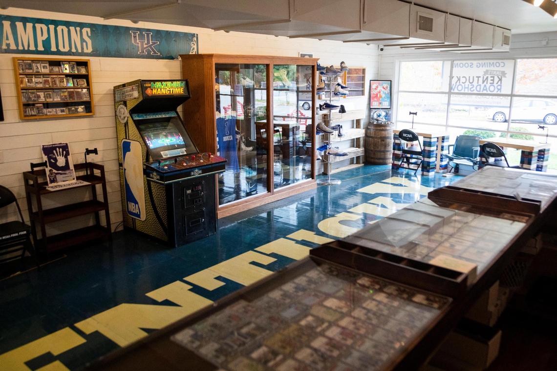Cards, jerseys, shoes and banners are just some of the items at Jimmy’s Kentucky Roadshow in Lexington. Part of the original Rupp Arena court serves as the floor for much of the store.