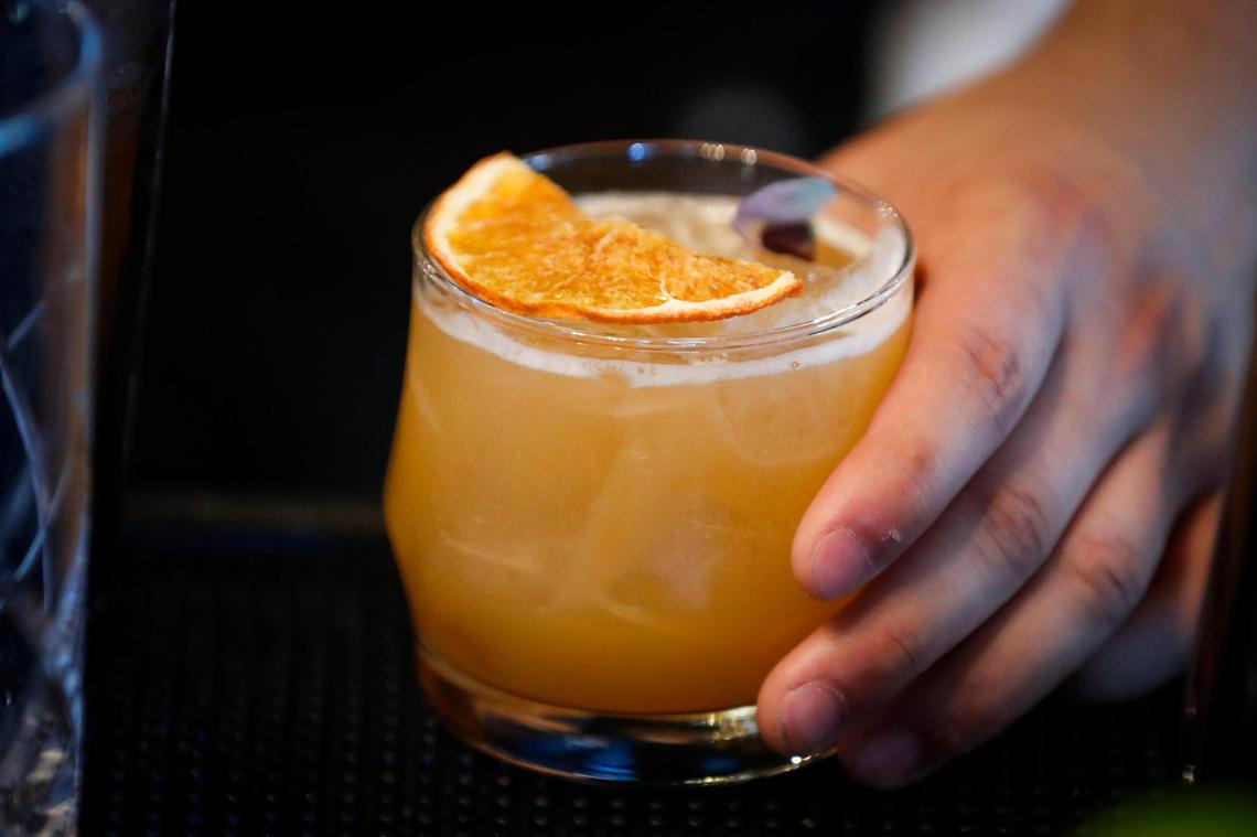 The Secret Lies With Charlotte cocktail made with Hornitos tequila, Sombra Mezcal, orangecello, house made honey syrup, lime juice, orange juice, and a habanero shrub from Harvey’s Bar at The Grove in Lexington, Ky., Thursday, May 27, 2021. The Grove is collaboration space between Harvey’s Bar and beer garden, Fable, which offers wine and charcuterie boards, Luna, a food truck and a new event space called The Melodeon.