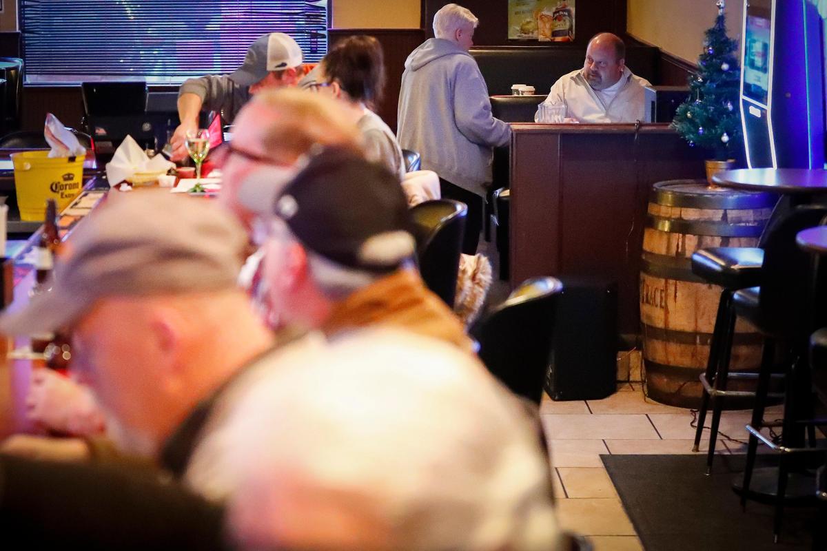 Betsy Joyce speaks with trivia host Dave Willoughby during a Dec. 11 round at Spud’s Sports Pub in Lexington.