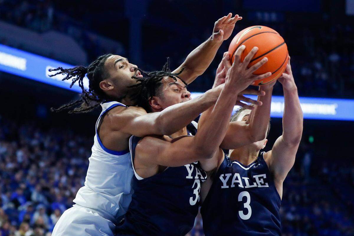 Kentucky’s Jacob Toppin, left, reaches for a rebound over Yale’s Isaiah Kelly (35) during Saturday’s game. Toppin finished with four points, five rebounds and four assists.