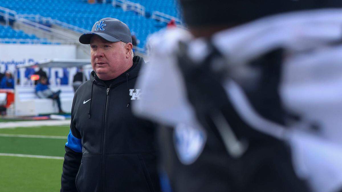 Kentucky head coach Mark Stoops walks off the field following his team’s 41-14 loss against Louisville on Saturday at Kroger Field.