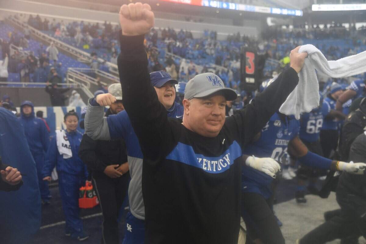 Mark Stoops celebrated after the Wildcats completed a 7-5 regular season by beating Louisville at Kroger Field on Saturday.