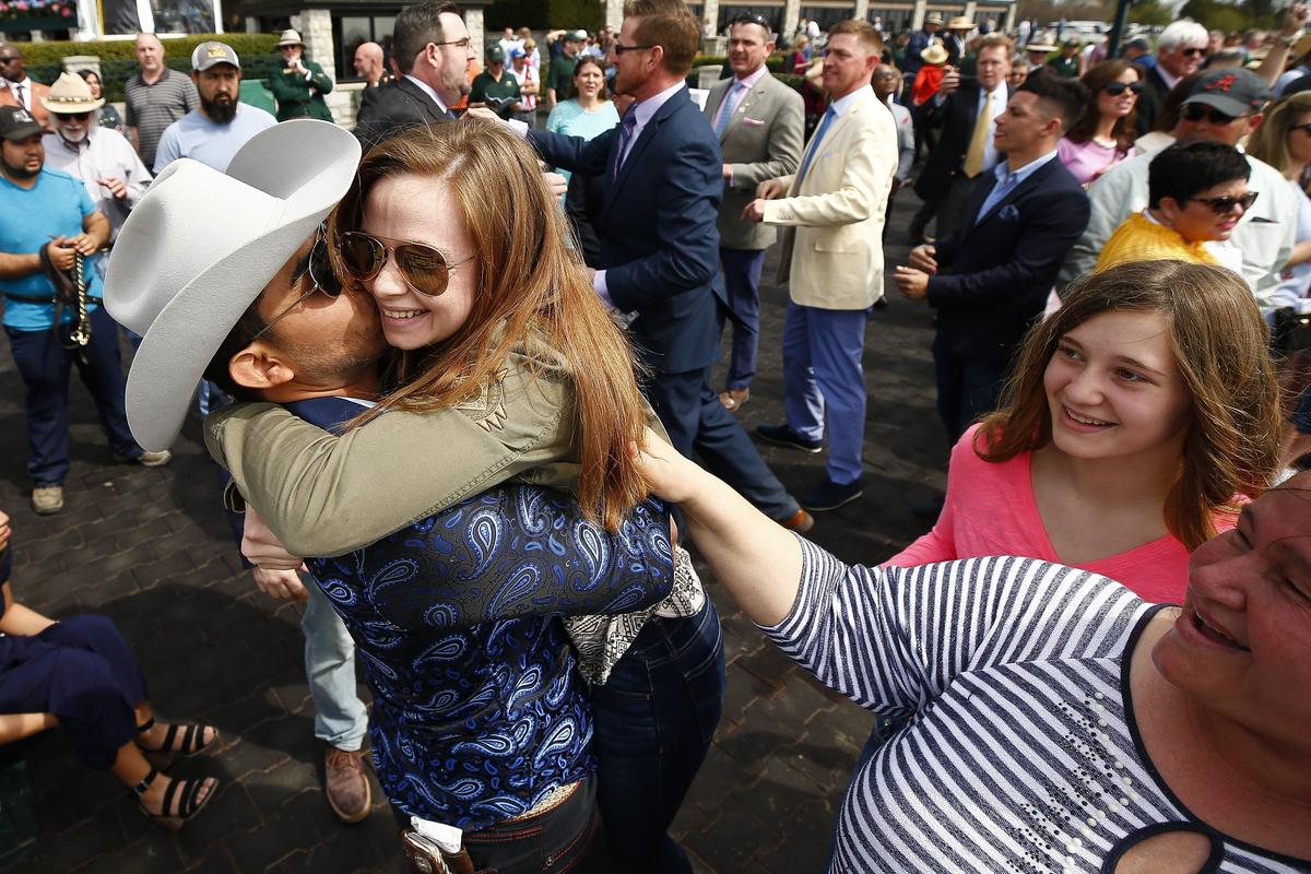 Trainer Cirilo Gorostieta and owner Savannah Goebel celebrated after their horse, Mean Sophia, won The Shamrock Glen Julep Cup in the first race Thursday during opening day at Keeneland.