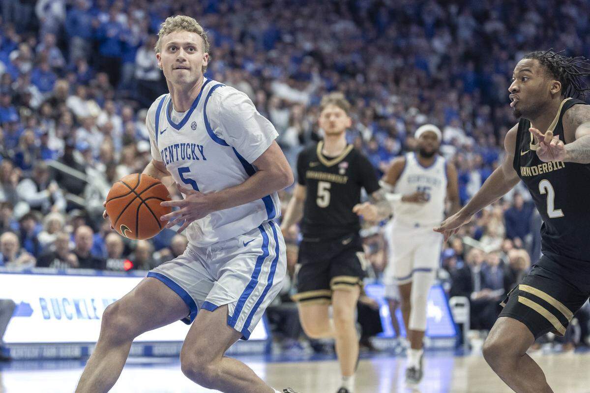 Kentucky guard Collin Chandler (5) looks to shoot the ball as Vanderbilt guard MJ Collins Jr. (2) defends during Wednesday’s game at Rupp Arena.