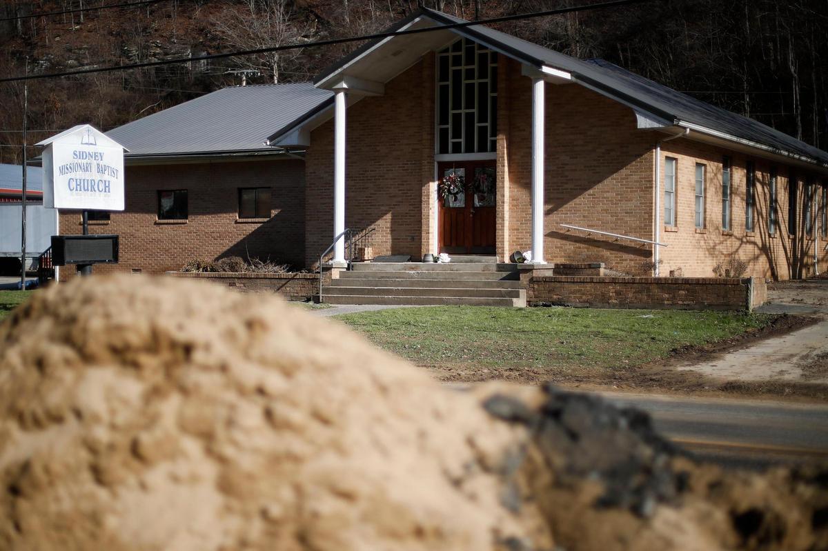 A pile of dirt from Big Creek sits across the street Sidney Missionary Baptist Church in Sidney, Ky., Thursday, Jan. 13, 2022. The church building was damaged in on flood on Jan. 1.