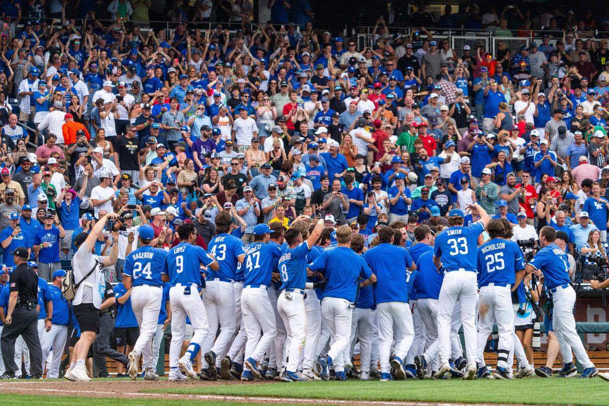 Jun 15, 2024; Omaha, NE, USA; The Kentucky Wildcats celebrate after a walk off home run by third baseman Mitchell Daly (2) against the NC State Wolfpack during the tenth inning at Charles Schwab Filed Omaha. Mandatory Credit: Dylan Widger-USA TODAY Sports