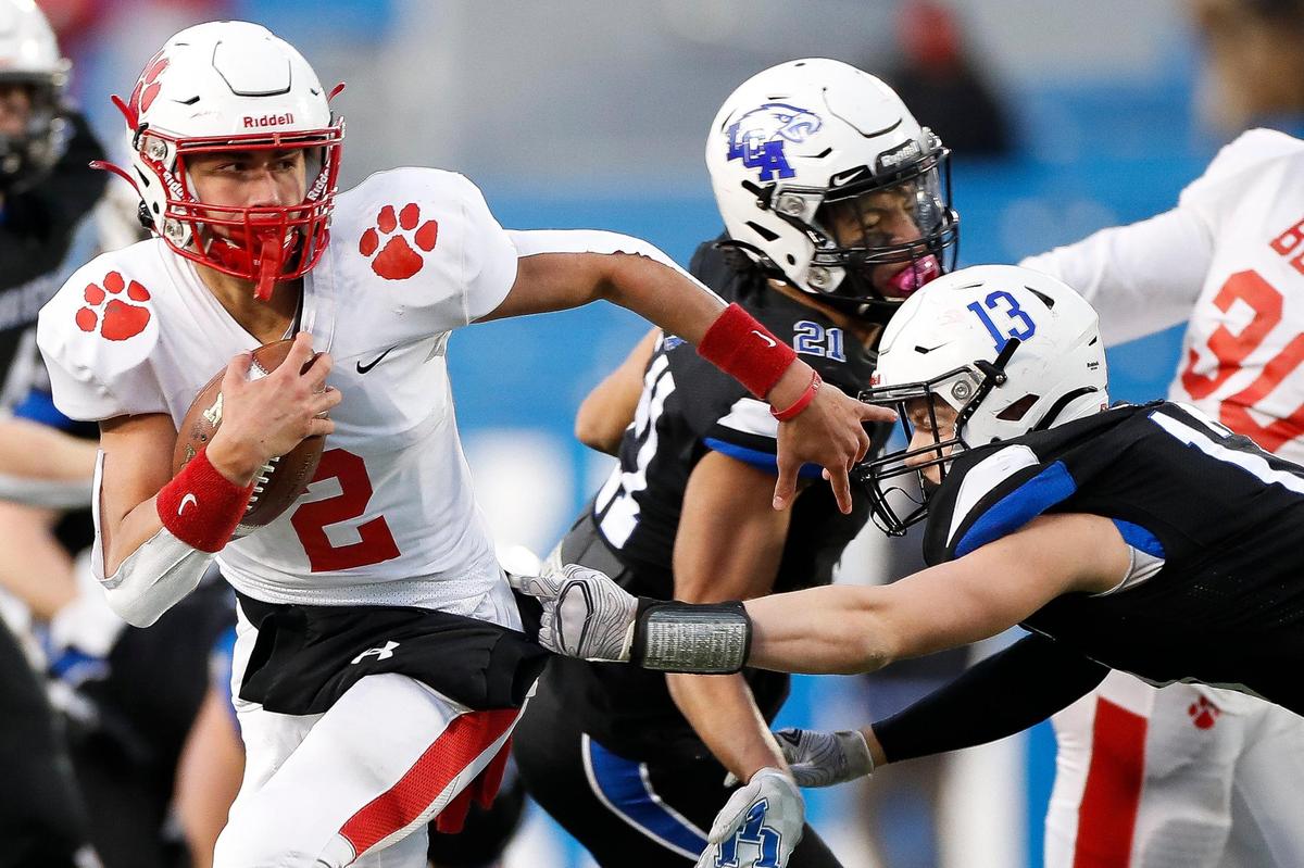 Beechwood’s Cameron Hergott (2) ran past Lexington Christian’s Elijah Hammond (13) during the Class 2A finals at Kroger Field on Dec. 18, 2020. Beechwood won 24-23 in overtime.