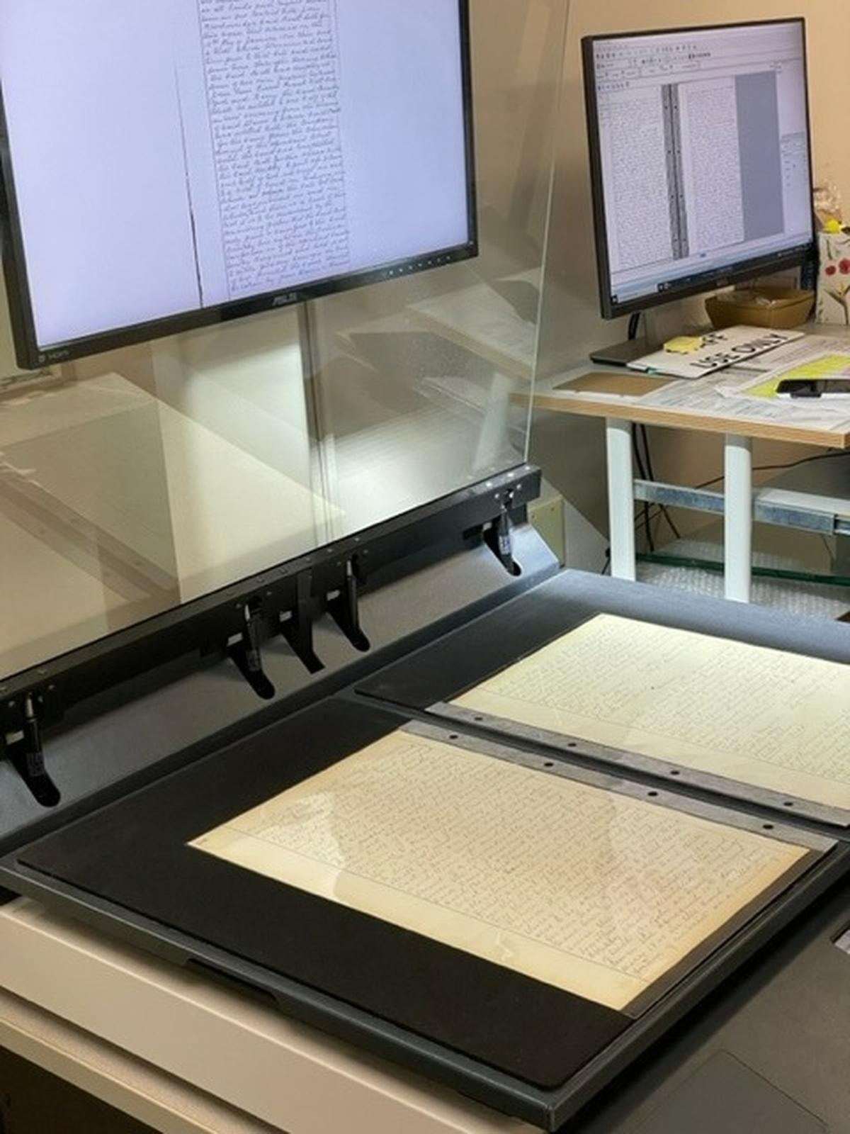 A deed book is scanned in the Fayette County Clerk’s office as part of the Digital Access Project. The project took Lexington’s earliest land and slave records and made them available online.
