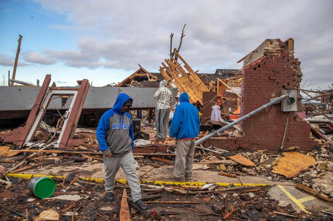 Workers and volunteers salvage what they can from the former La Azteca, a grocery store and restaurant, in downtown Mayfield, Ky., on Saturday, Dec. 11, 2021. A deadly tornado ripped through the area Friday night.