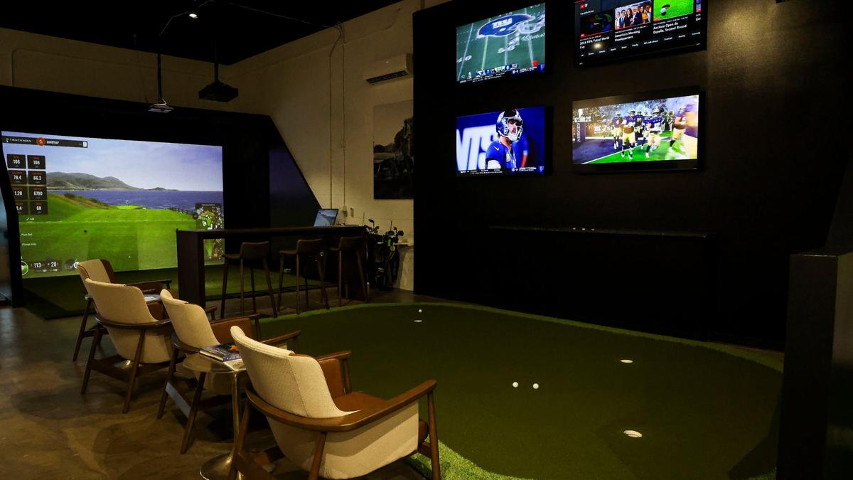 The Sand Trap has a putting green and 12 TVs. Co-owner Eric Bivins said they often have games on the TVs.