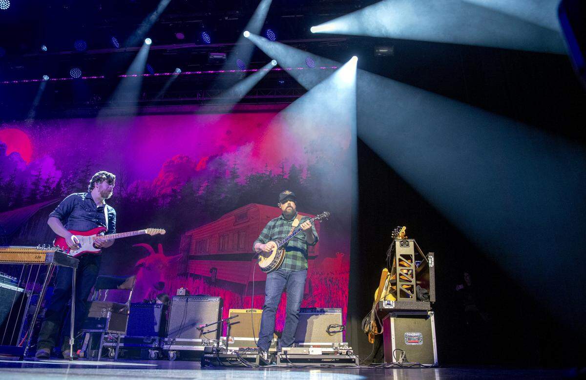 James Barker, left, and Jesse Wells, right, perform with Tyler Childers Friday, Feb. 7, 2020, at the Ryman Auditorium in Nashville, Tenn. Barker and Wells are part of Childers band, the Footstamps. Childers is the middle of a four-night residency at the Nashville institution, with the remaining shows Feb. 15 and 16. Wells is a traditional music instructor at Morehead State University.