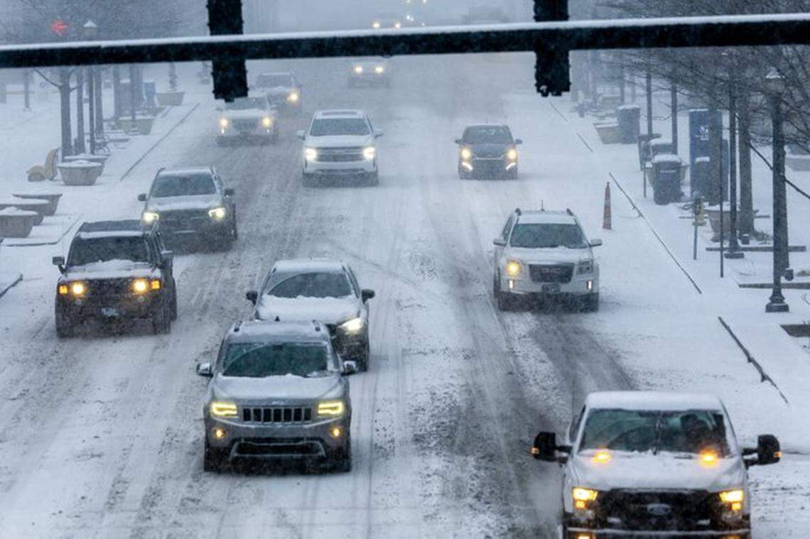 Cars travel along snow-covered Lexington roads Sunday, Jan. 5, 2025, as a winter storm sweeps across the commonwealth.