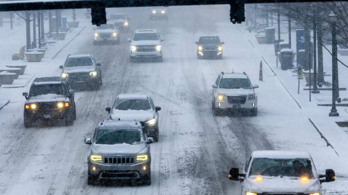Cars travel along snow-covered Lexington roads Sunday, Jan. 5, 2025, as a winter storm sweeps across the commonwealth.