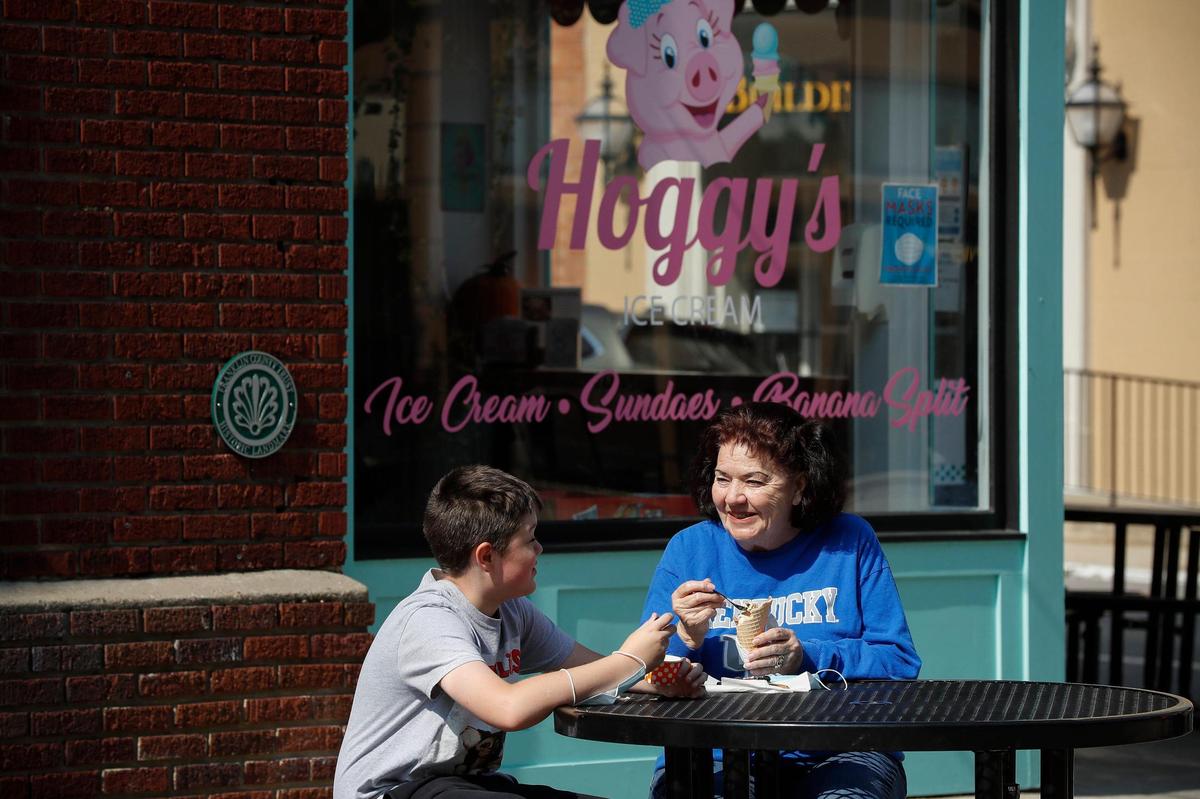 Linda Long, jokes with her grandson Brody Long-Eastman, 11, both of Frankfort, at table in front of Hoggy’s Ice Cream Oct. 6 in Frankfort. Brody surprised his grandmother by buying her ice cream as they were out Tuesday afternoon. There are several tables outside Hoggy’s.