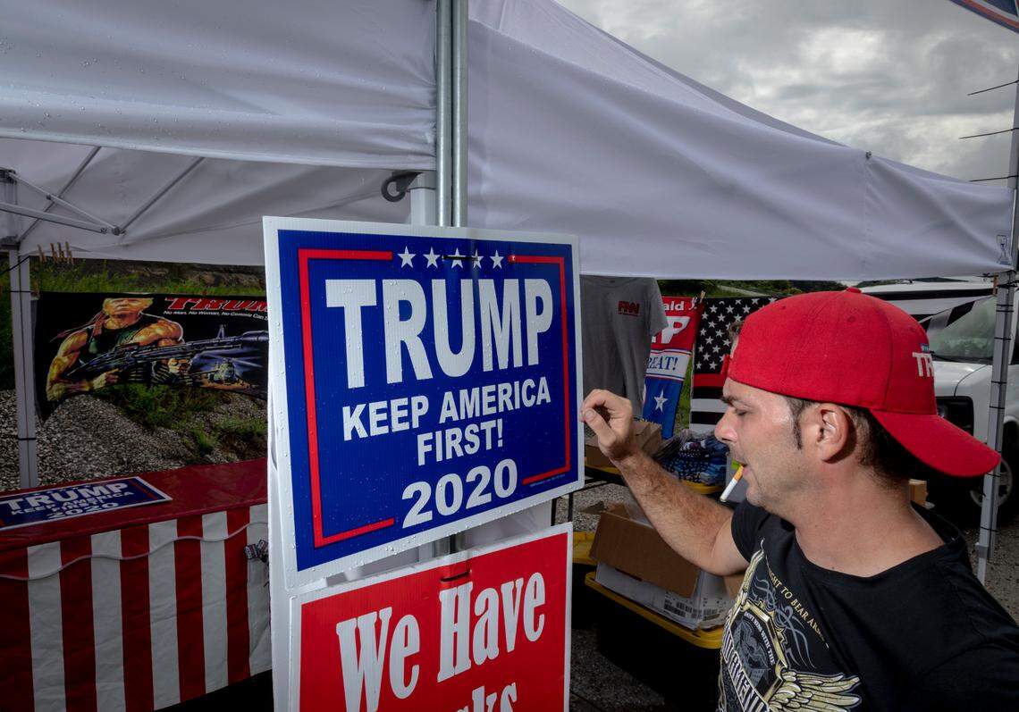 Fabio Ferreira, of Florida, sets up some merchandise supporting President Trump at a tent in Hazard, Ky., Friday, August 21, 2020. Ferreira moves to different areas every couple of weeks.