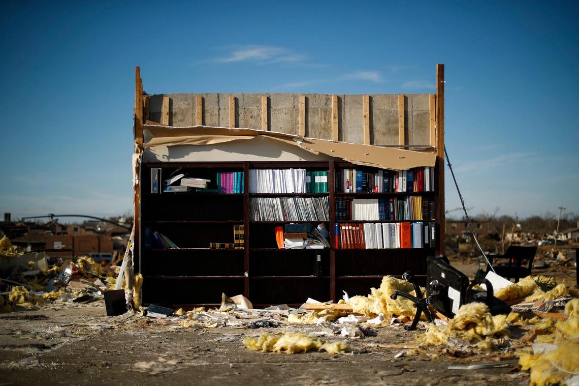 Only a bookshelf remains in the former law office of Hargrove & Foster at the corner of East North Street and North 6th Street following last week’s deadly tornadoes in Mayfield, Ky., Tuesday, Dec. 14, 2021.