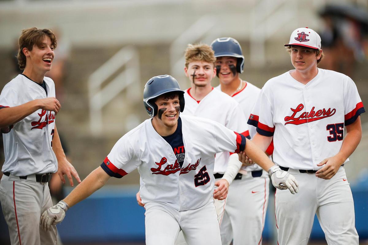 Russell County’s Nathan Lawson (25) celebrates after hitting a home run to win the game against Woodford County in the state baseball semifinals at Kentucky Proud Park.
