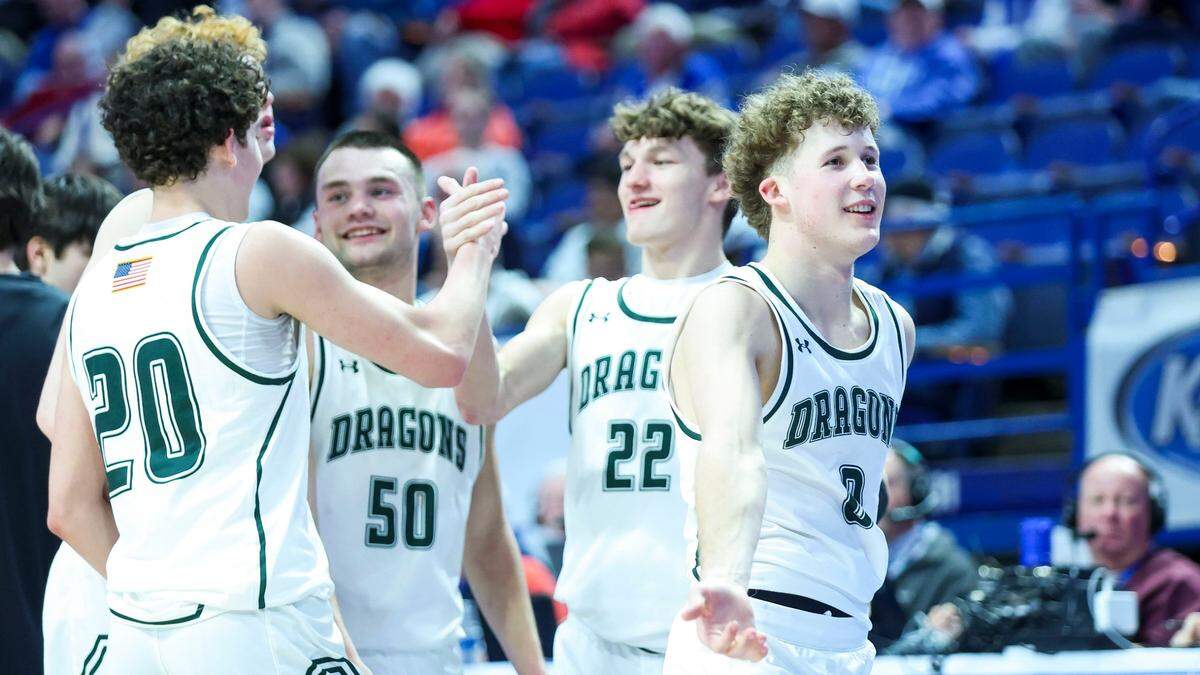 Drew Campbell (20), Julian Miles (50), Adrian Miles (22) and Jake Fithian (0) celebrate South Oldham’s win over Danville Christian Academy in Rupp Arena on Wednesday night.