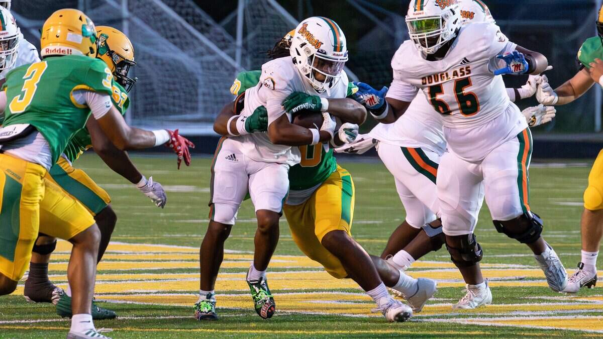 Bronco's RB Dakari Talbert (6) runs up the middle for yards gained during the Class 6A, 8th District battle between Frederick Douglass and host Bryan Station on Oct. 17, 2025, in Lexington, Ky.