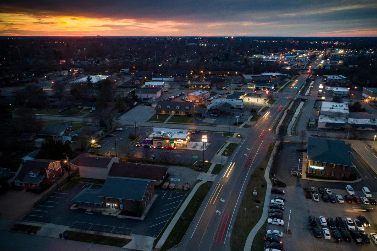 Motorists travel along Southland Drive at sunset in Lexington, Ky., Saturday, March 13, 2021.
