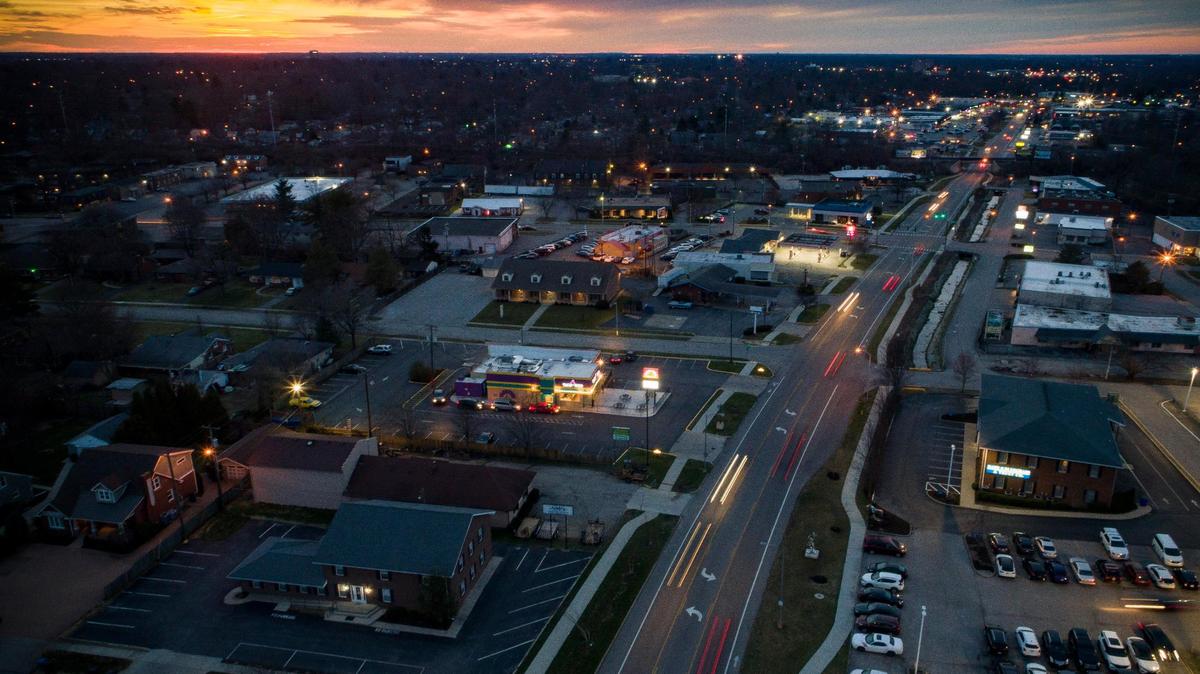 Motorists travel along Southland Drive at sunset in Lexington, Ky., Saturday, March 13, 2021.