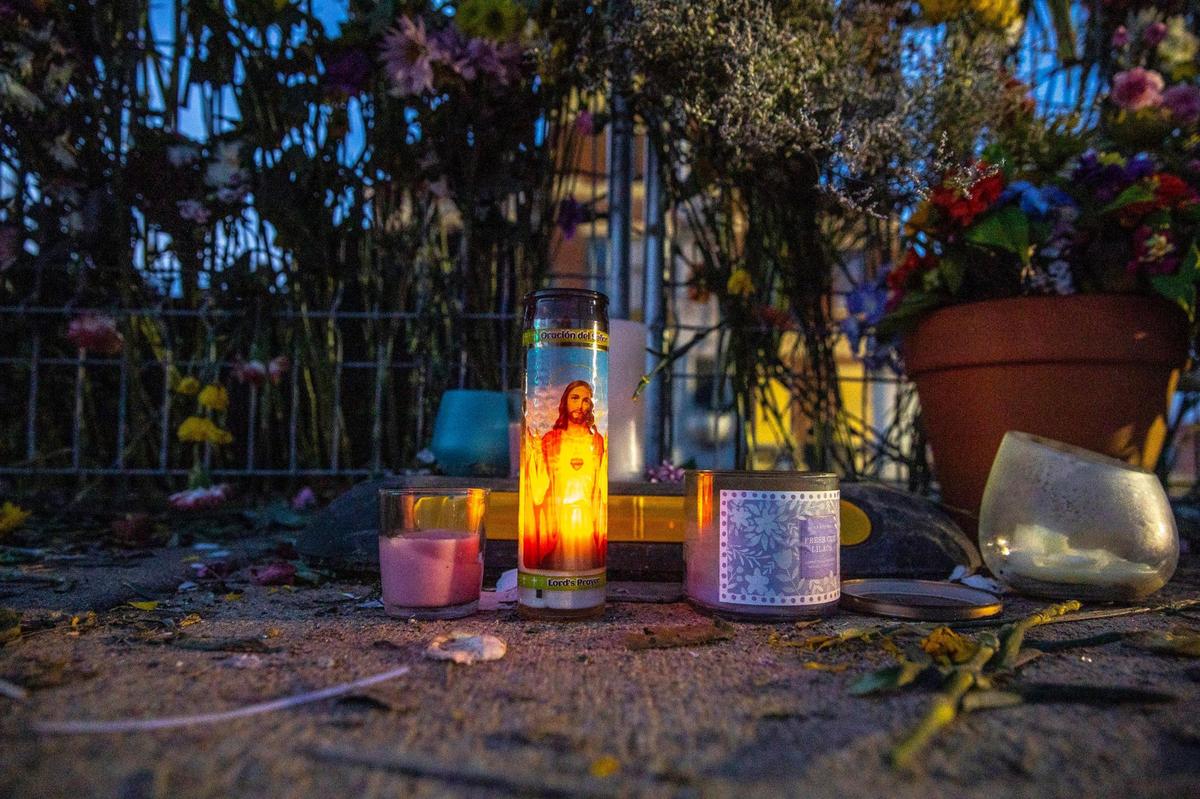 Flowers are placed on a temporary fence outside the Graves County Courthouse in Mayfield, Ky., on Monday, Dec. 20, 2021.