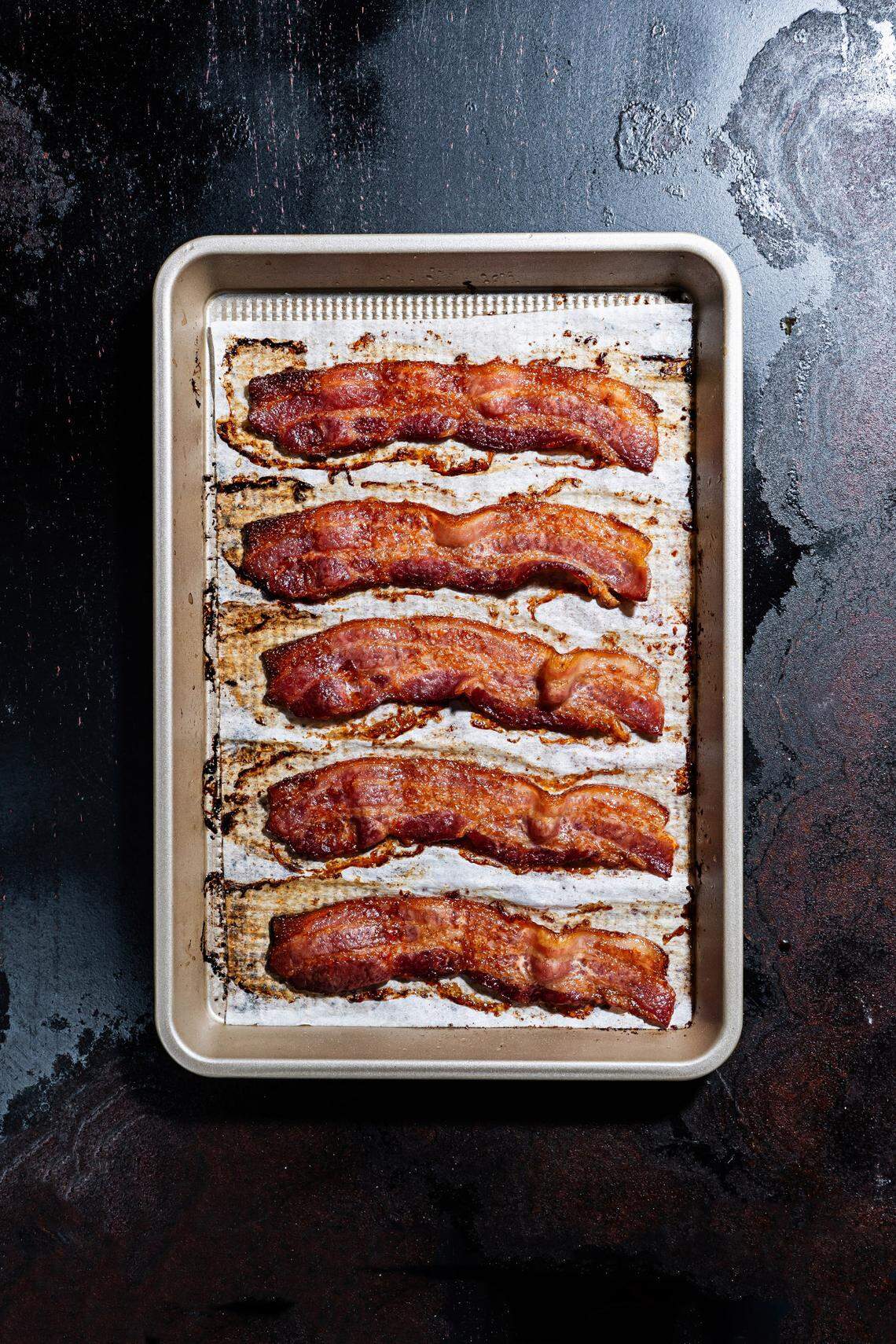 Bacon cooked in an oven on a sheet pan is a more hands-off approach. Line with parchment or foil for easier cleanup.