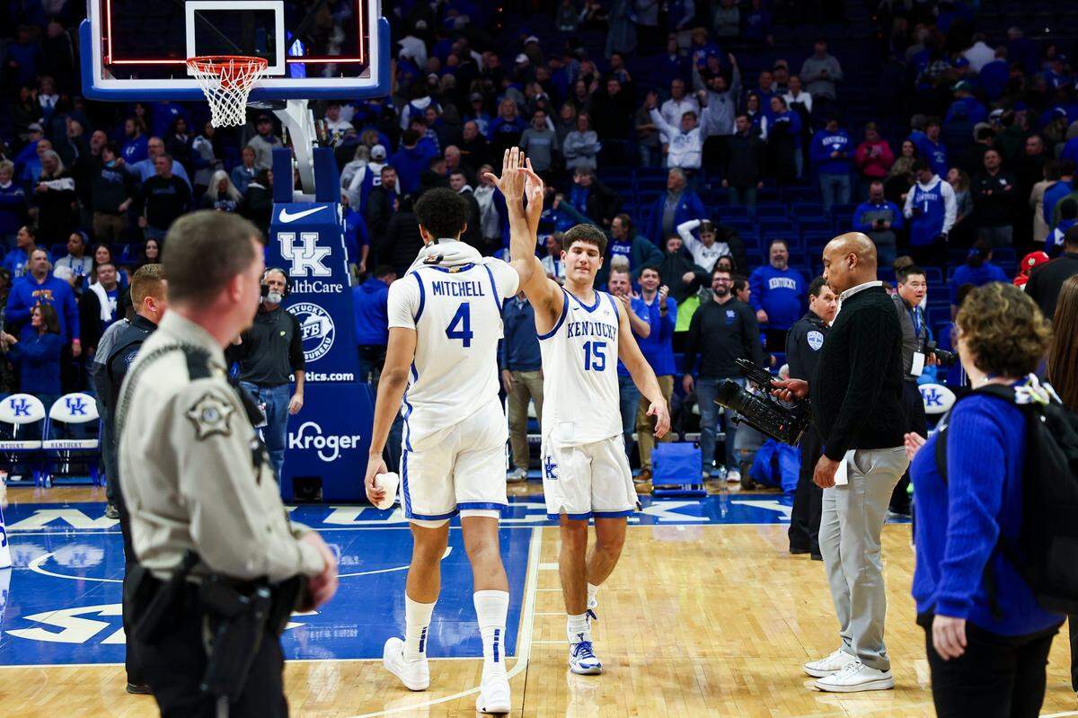 Kentucky’s Reed Sheppard (15) high-fives Tre Mitchell (4) after the Wildcats routed No. 8 Miami in the ACC/SEC Challenge in Rupp Arena on Tuesday night.