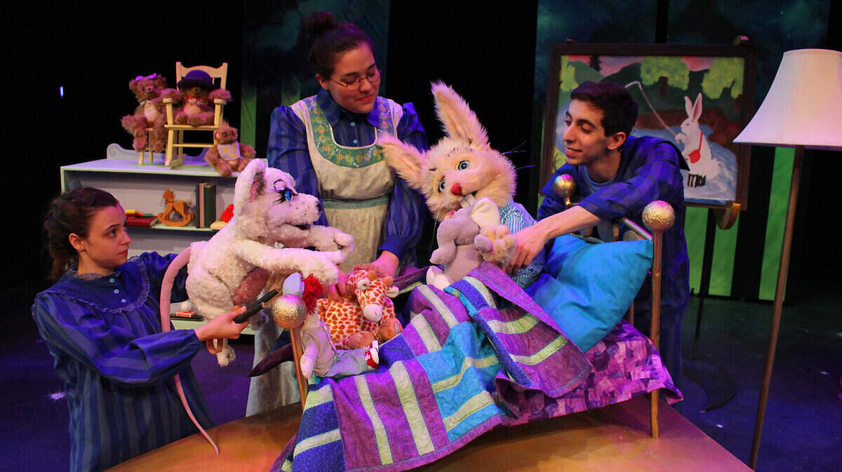 Old Lady (Sara Vazquez), center, tries to get Mouse (Carly Crawford), left, and Bunny (Carlos Leon) to go to bed, but they won't go without their favorite toys in Lexington Children's Theatre's production of Goodnight Moon.      