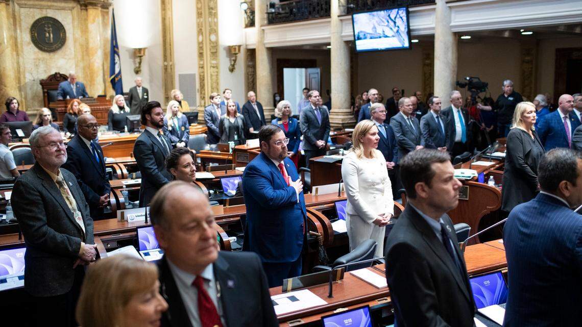 Members of the Kentucky Senate stand for the playing of the national anthem and My Old Kentucky Home on the opening day of the 2023 legislative session for the Kentucky General Assembly at the Capitol in Frankfort, Ky., Tuesday, January 3, 2023.