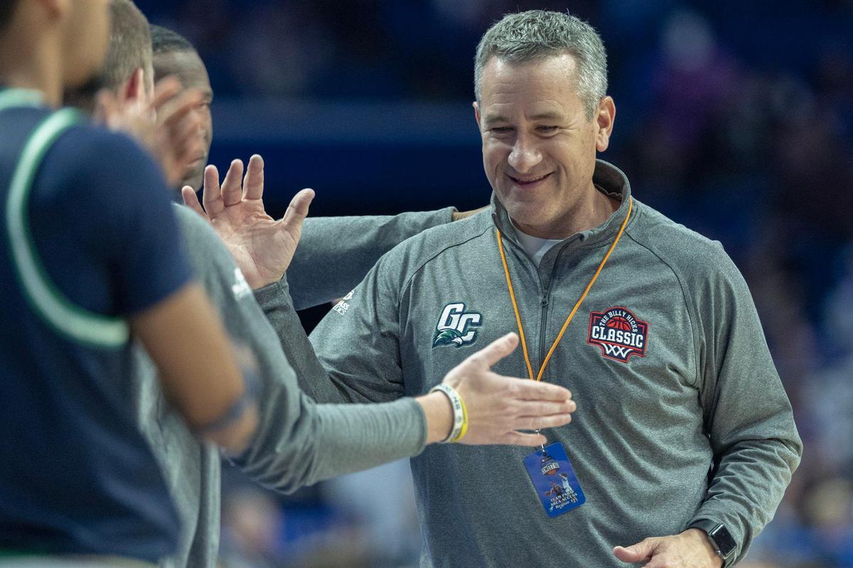 Great Crossing head coach Steve Page high-fives his players during the Sweet 16 state championship game at Rupp Arena on Saturday.
