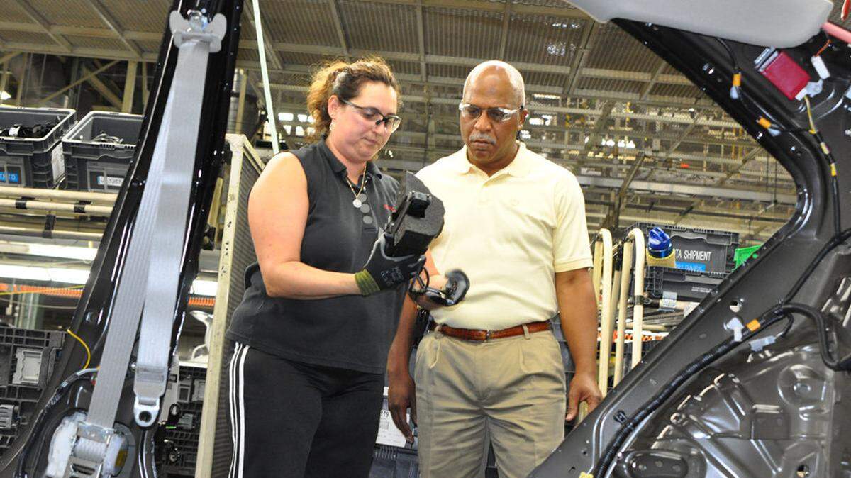 Wil James, the new president of Toyota's Georgetown plant, spoke with employee Jade James on the plant's assembly line.    
