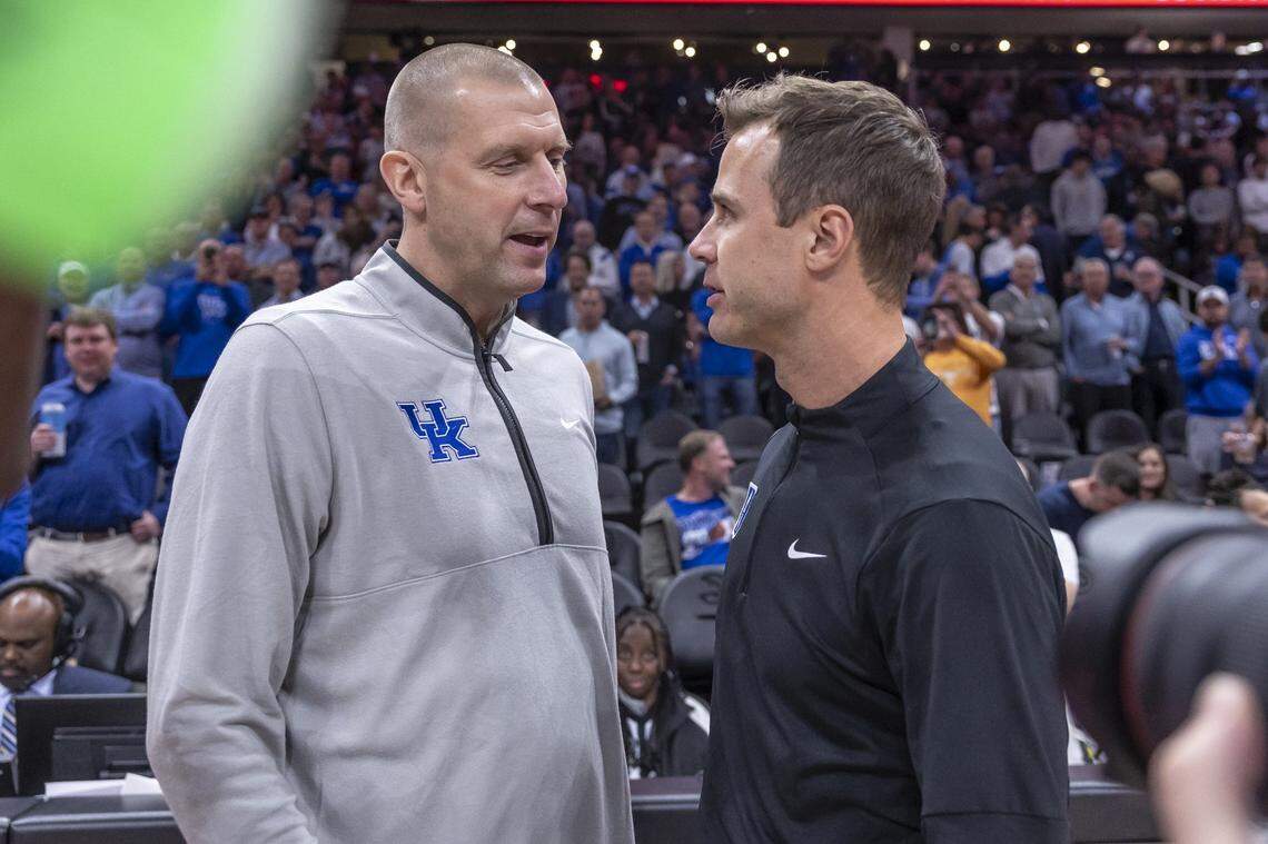 Kentucky head coach Mark Pope talks with Duke head coach Jon Scheyer before Tuesday night’s Champions Classic game in Atlanta.